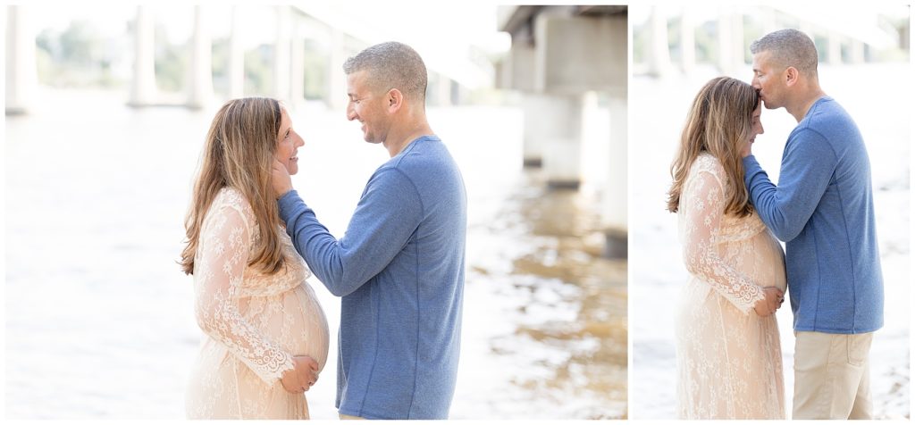 husband kisses pregnant wife's forehead at Annapolis waterfront