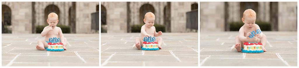 toddler boy digs into birthday cake