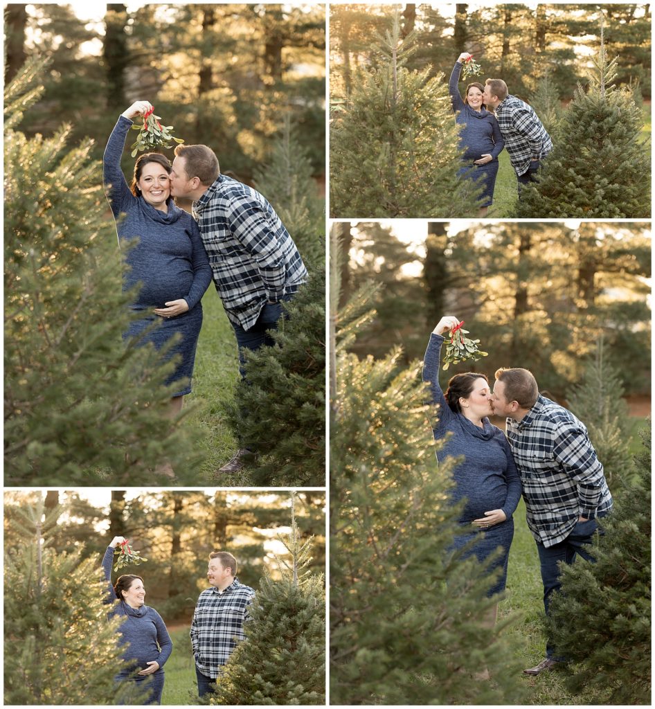 wife holds mistletoe over head in Christmas tree maternity photos