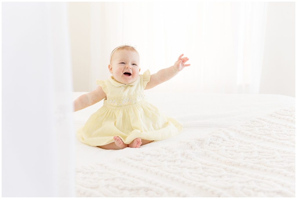 It's too cold and I don't wanna but I will for this baby in yellow dress on white bed