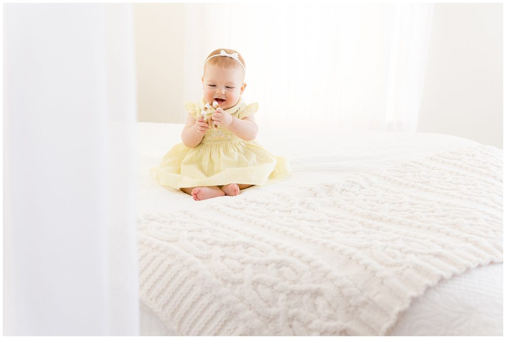 cute baby photos, white bed, yellow dress