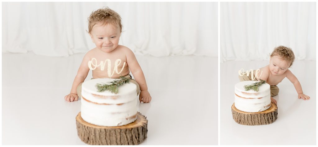 baby considers cake at themed one year cake smash