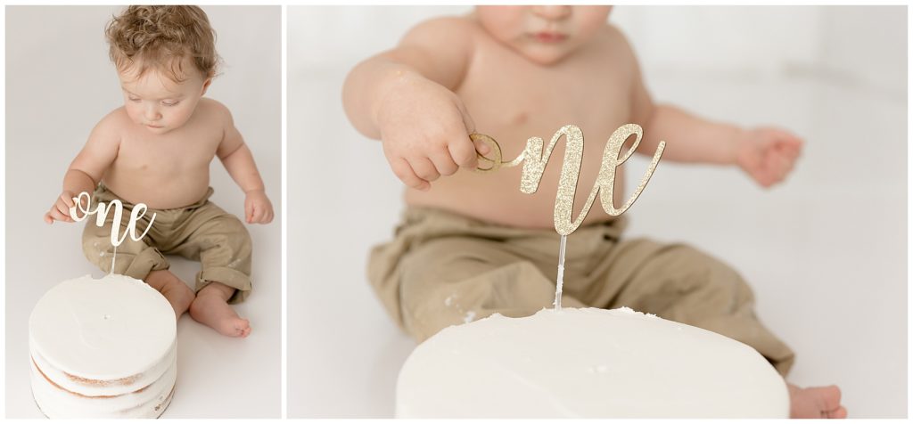 baby plays with one sign on birthday cake