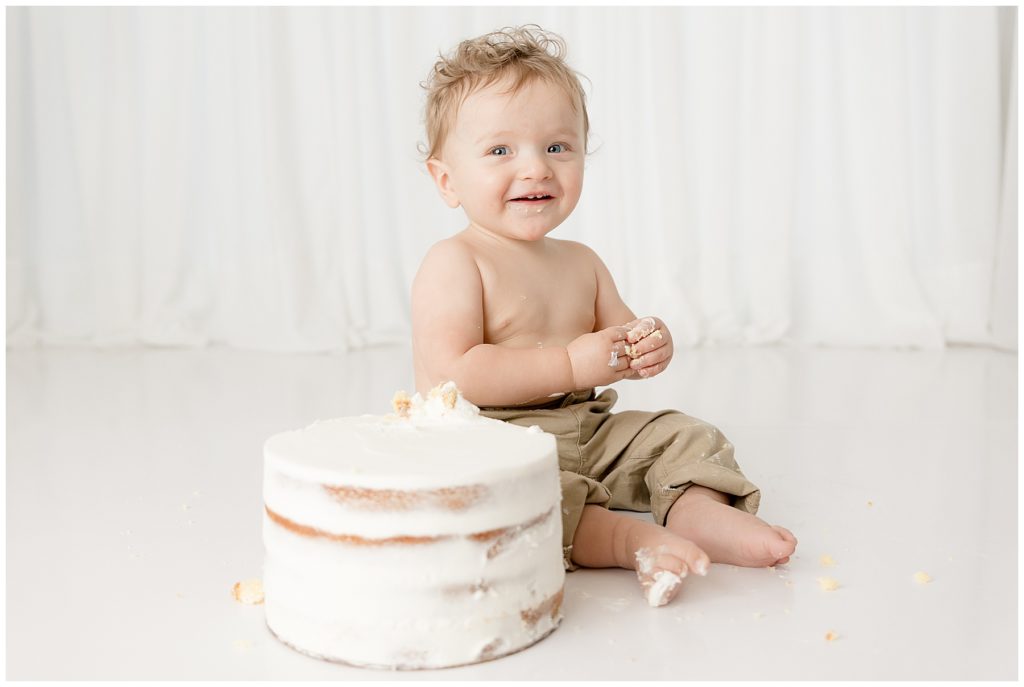 smiley baby covered in cake at Burtonsville photo studio