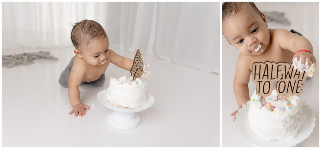 cute six month old baby grabs cake