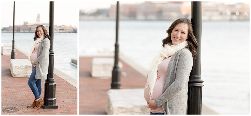 pregnant woman leans against Fells Point light post