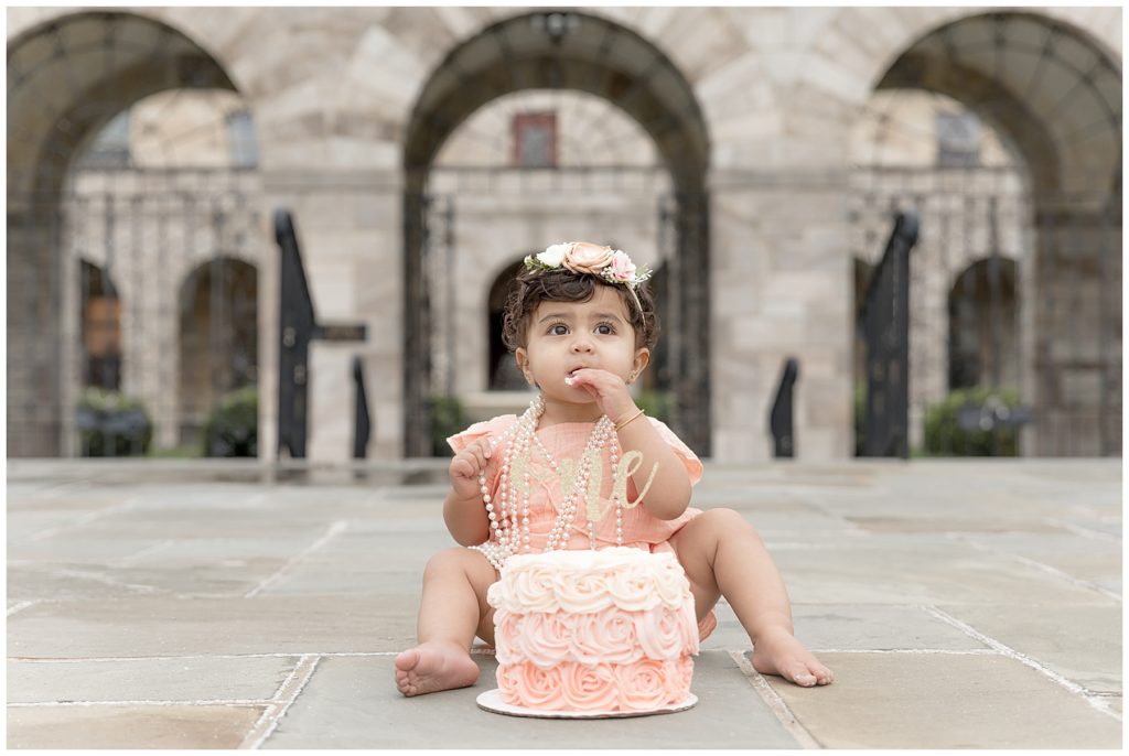 baby tastes her birthday cake