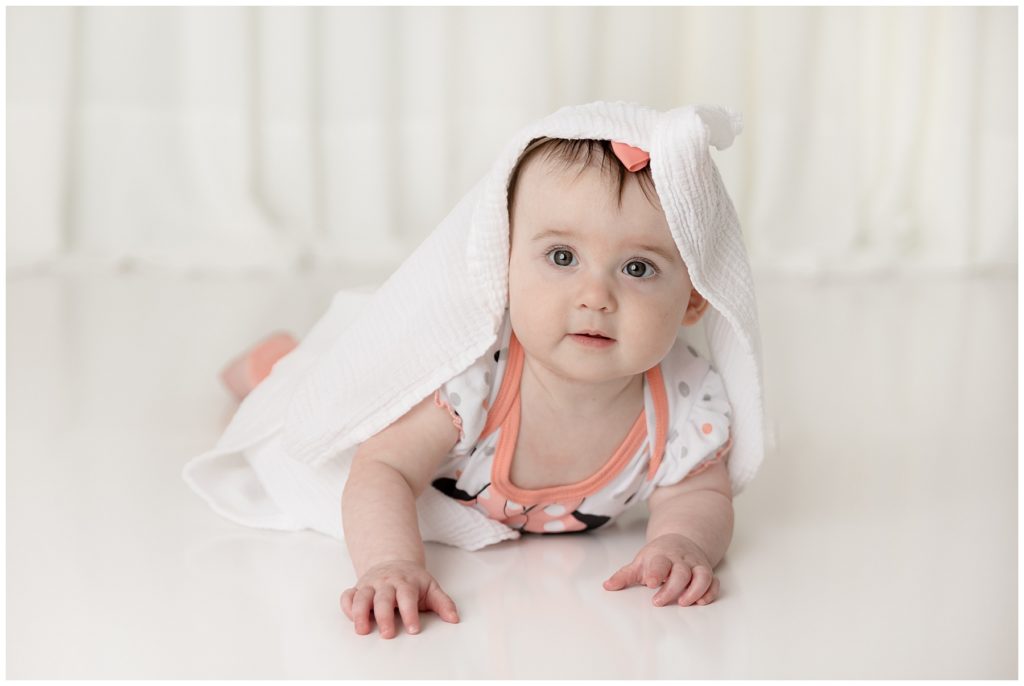 white blanket on baby's head, sitter session photos