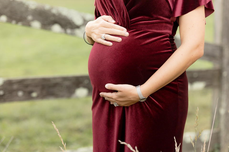 pregnant belly in merlot dress