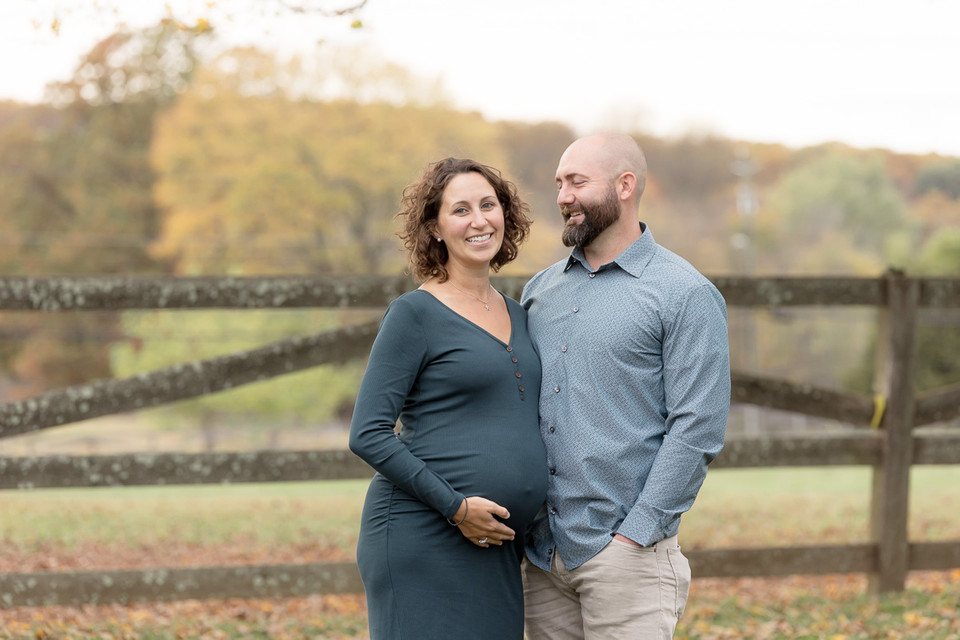 husband smiles at pregnant wife