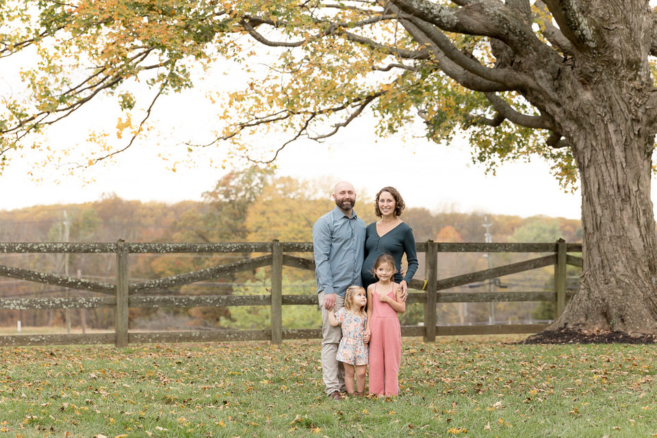 pullback family portrait under fall tree