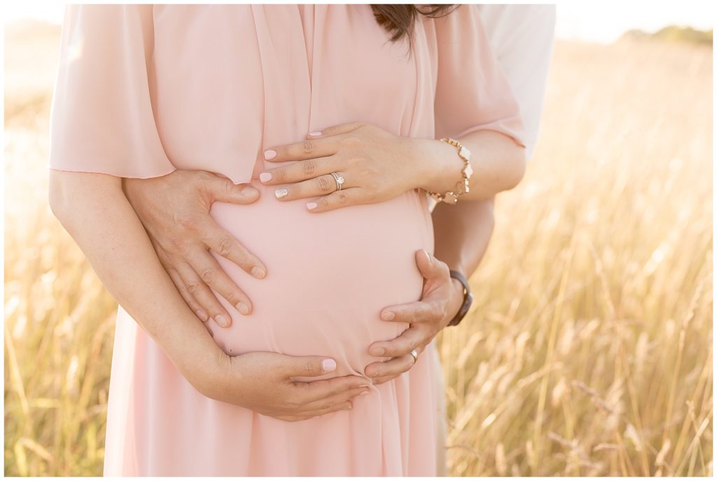 pregnant belly shot in golden field