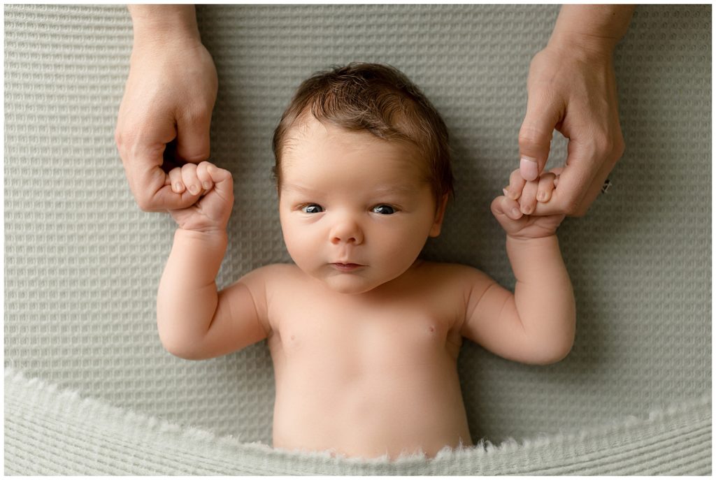 newborn session poses - muscle man