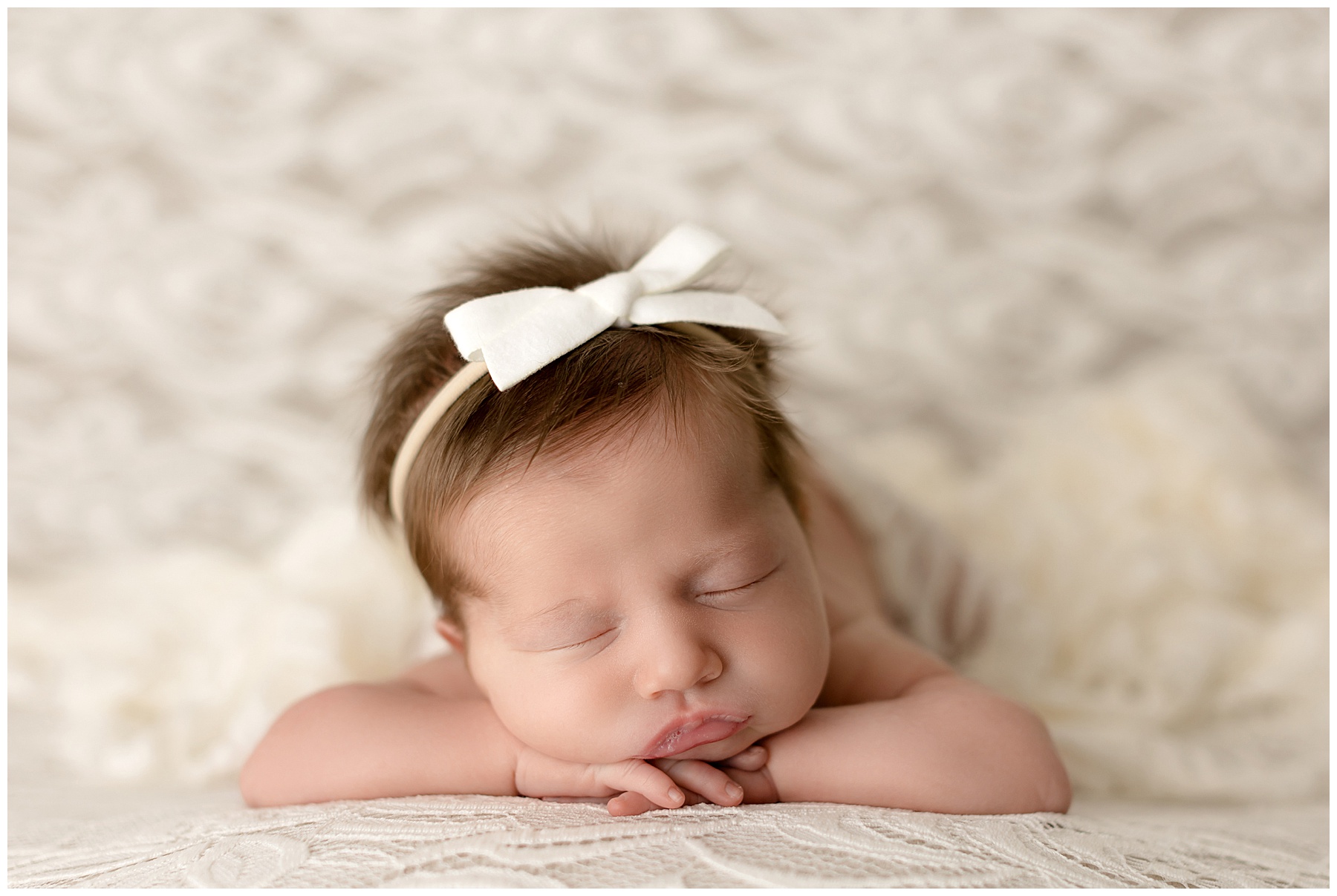 newborn head on hands pose