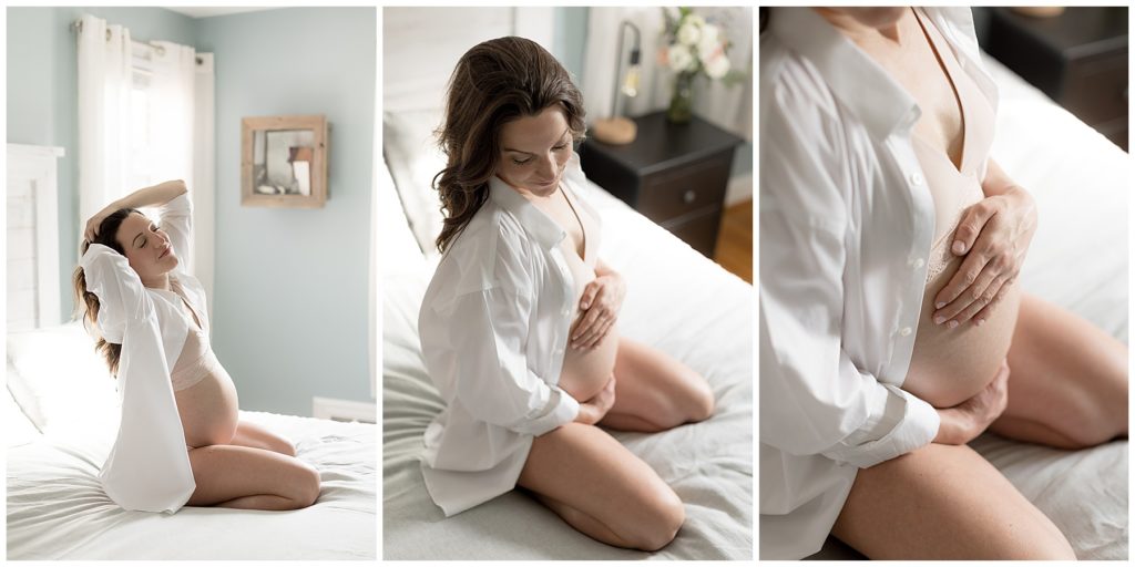 pregnant woman in white shirt shows belly on bed