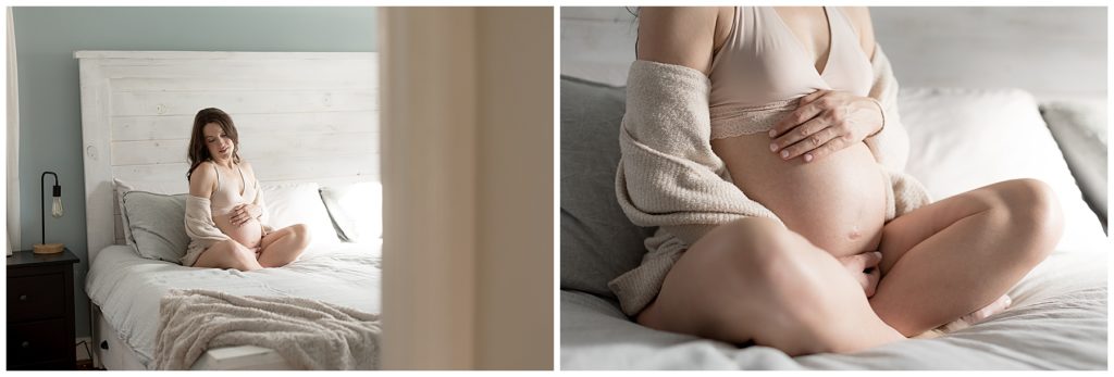 boudoir maternity session, sweater shows pregnant belly on master bed