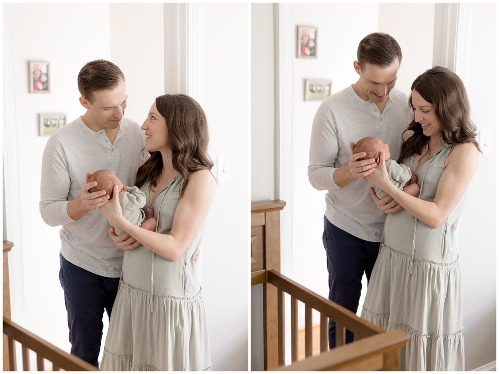 couple stands in doorway with new babe, not perfect but perfect together