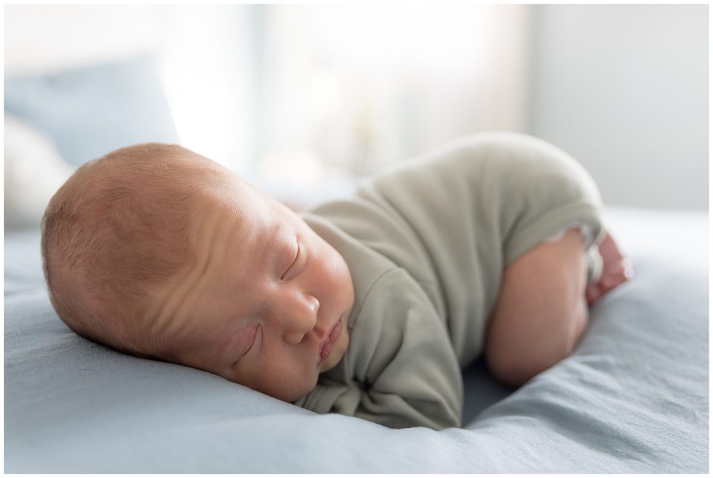 newborn baby snoozes on tummy