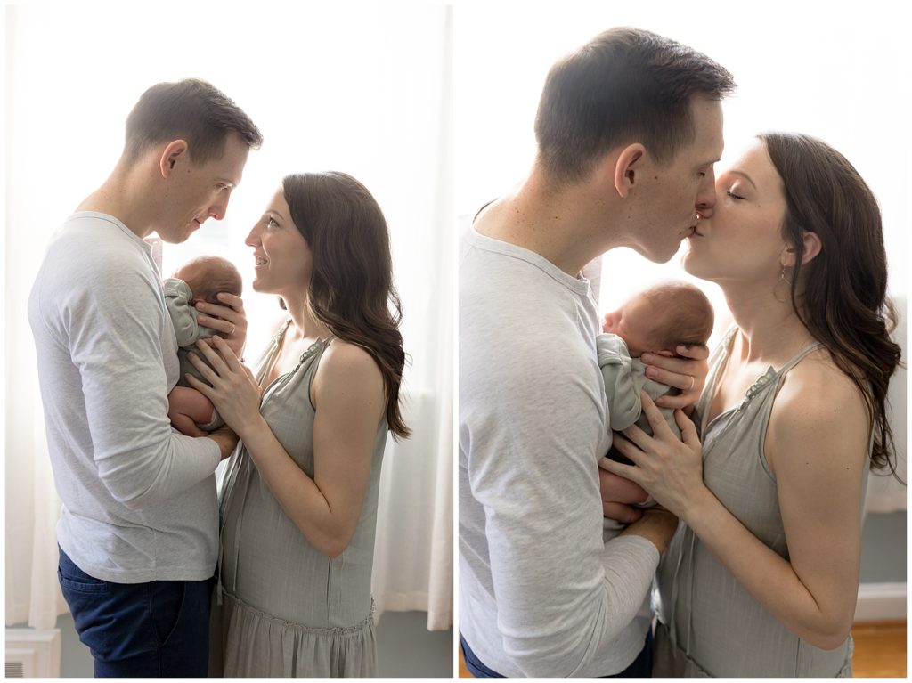parents kiss over newborn son
