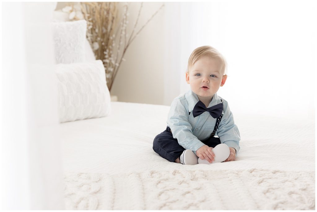 prepare for baby's sitter session - baby on white bed