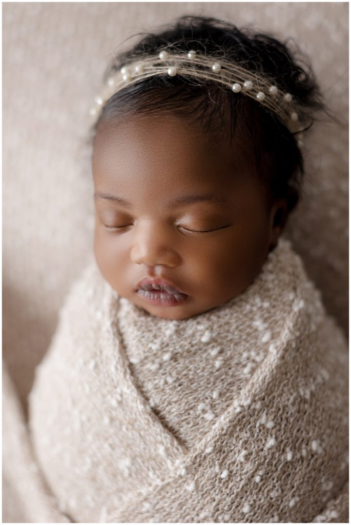 black newborn girl in pearl headband