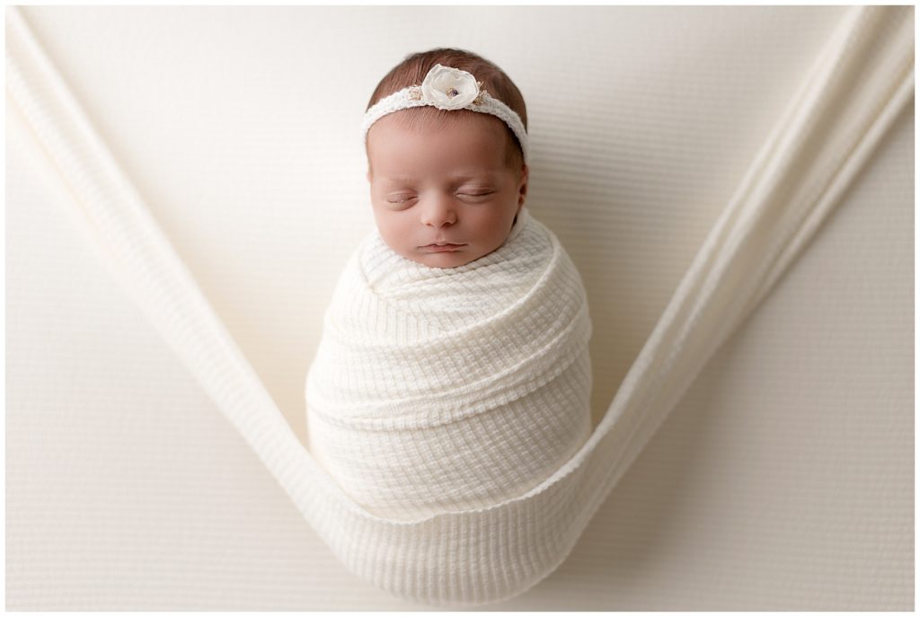 Newborn photos with a nurse, hammock pose
