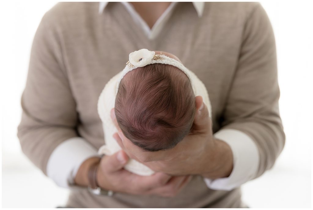 dad's strong hands, baby's fragile head, Newborn photos with a nurse