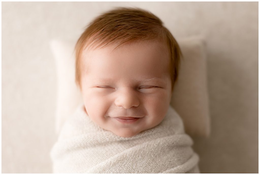 newborn smiles caught by newborn photographer