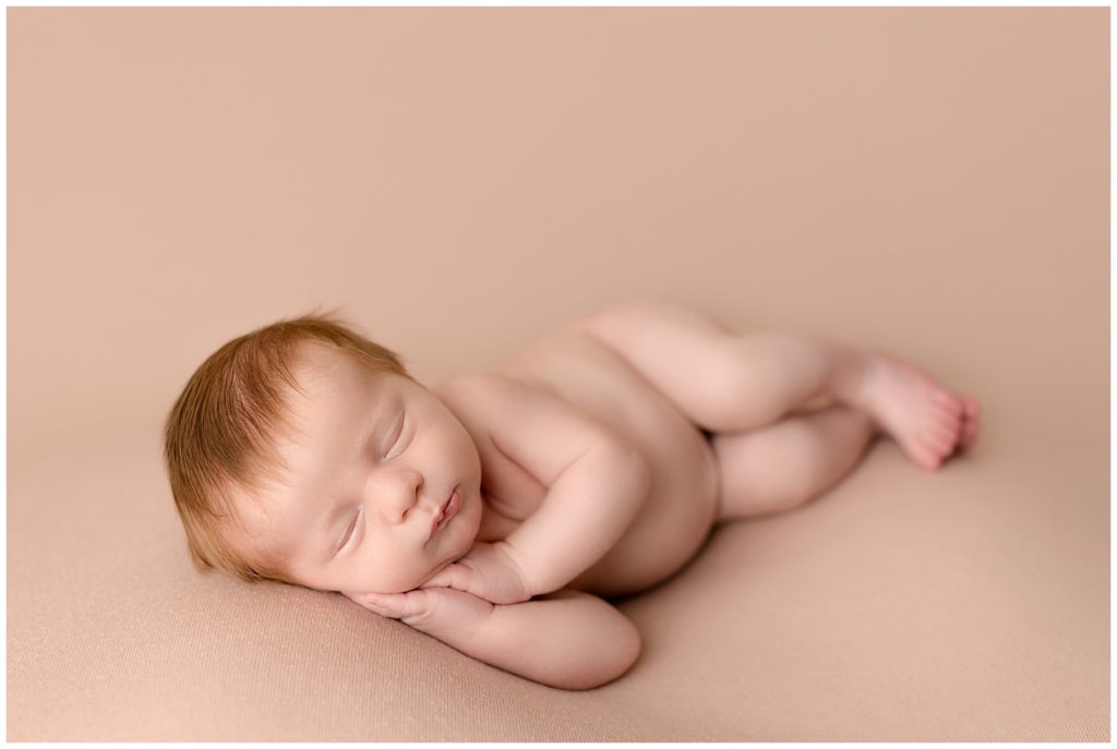 side lying newborn photographer pose