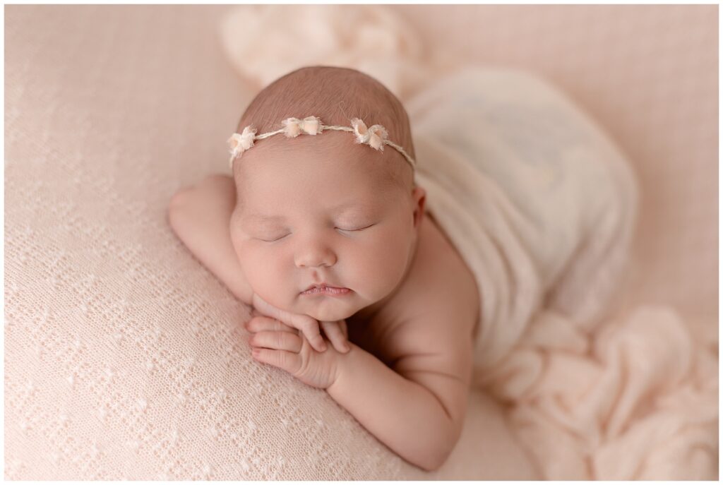 sweet baby girl in pink evokes emotion in newborn photography