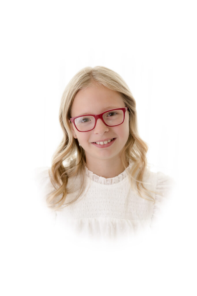 Heirloom Portraits - girl in red glasses and white smocked shirt
