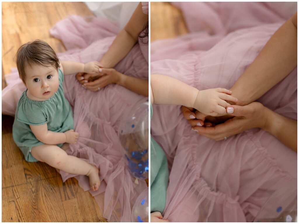 mom and baby hold hands during one year photoshoot