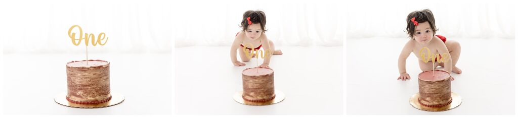 Red and gold cake awaits baby girl for her cake smash photography session