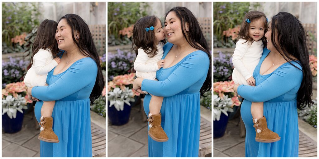 Toddler girl snuggles pregnant mama in blue maternity dress