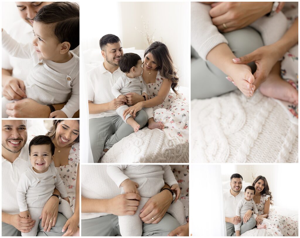 baby boy sits with parents on white bed for his first year photos