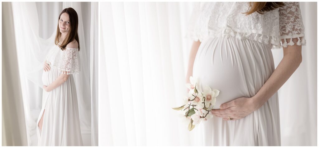 a woman poses near a window and hold a bouquet of flowers next to her pregnant belly for her studio maternity photos